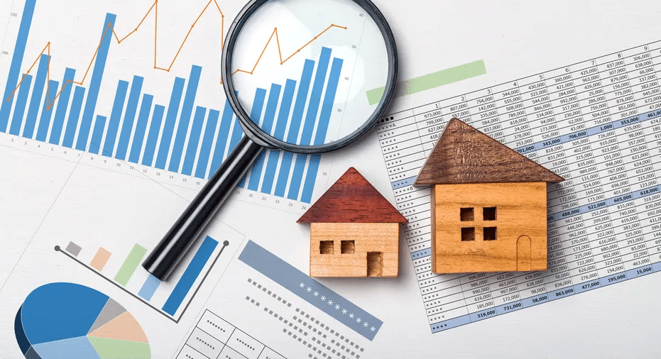 magnifier, small wooden houses and charts, flatlay